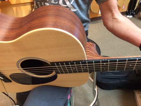 It's laminate...but it's still pretty. And Guitar Friend #2 assured me only the top of the guitar matters when it comes to sound.